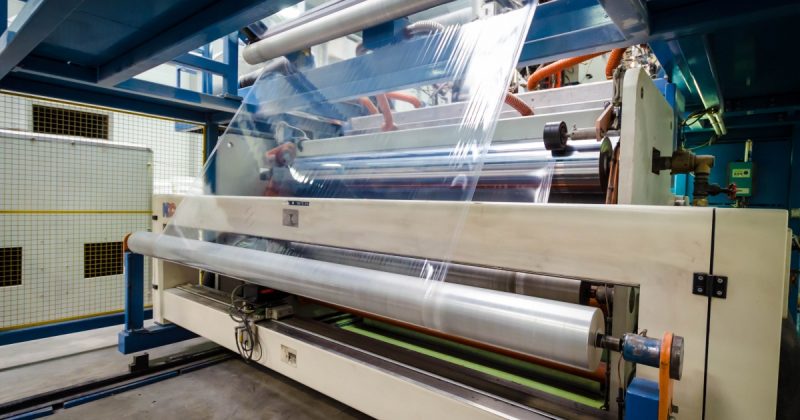 Stretch film moving through industrial production equipment