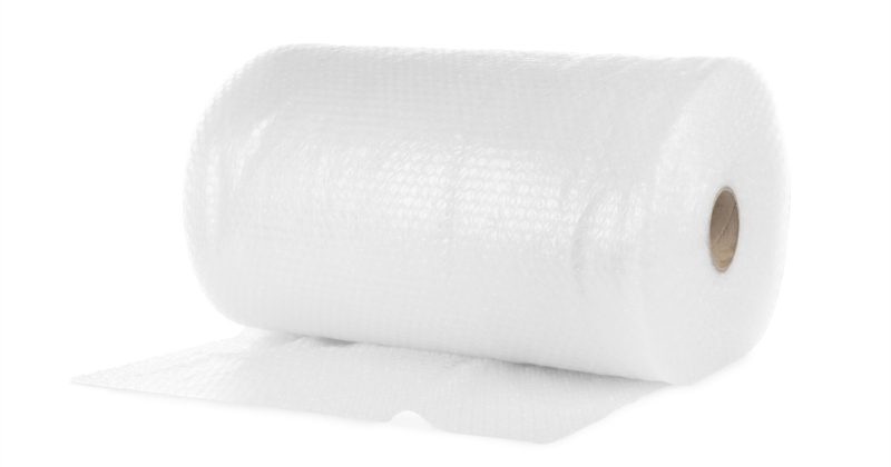 Unbranded bubble wrap rolls in an industrial packaging warehouse